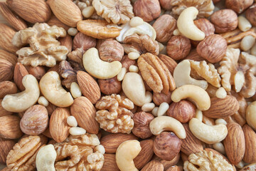 Different nuts. Home kitchen. Protein and fat food. Mix seeds. Raw whole snack. Munchies. Natural cuisine. Vegan. Peanut, almond, pine pecan hazelnut cashew