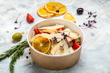 take away fresh salad in a lunch box. Caesar salad in paper bowl for take away, top view