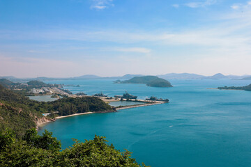 Fototapeta na wymiar High point view for looking at the location of Sattahip Naval Base with clear sky and blue sea. Sea view and the island close to Sattahip Naval Base, Thailand.