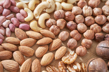 Different nuts. Home kitchen. Protein and fat food. Mix seeds. Raw whole snack. Munchies. Natural cuisine. Vegan. Peanut, almond, macadamia pecan cashew