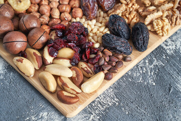 Different nuts. Home kitchen. Protein and fat food. Mix seeds. Raw whole snack. Munchies. Natural cuisine. Vegan. Cranberry, macadamia, pine and brasil hazelnut