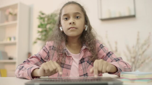 Smart girl typing on laptop keyboard, distance education, computer literacy