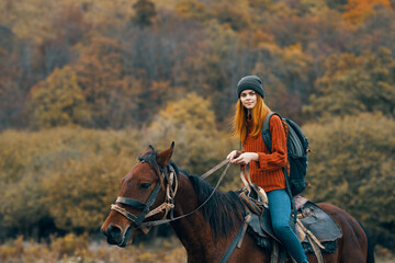 woman hiker riding a horse in the mountains walk fresh air travel