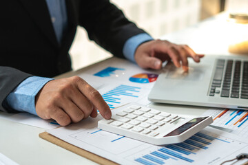 Fototapeta premium bookkeeper or financial inspector hands making report, calculating or checking balance. Home finances, investment, economy, saving money or insurance concept