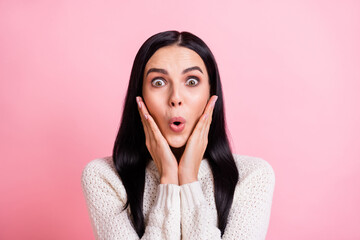 Photo of impressed funny young woman dressed white pullover arms cheek big eyes isolated pink color background