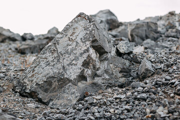 Mining process. Rocks for mining. Big gray limestone.