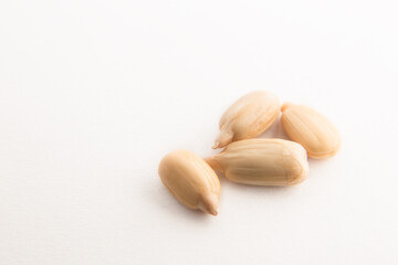 peeled sunflower seeds on a white background