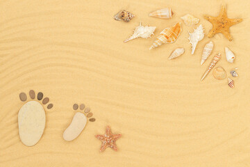 Fototapeta na wymiar Summer sandy background with seashells, starfishes and pebbles like human footprint