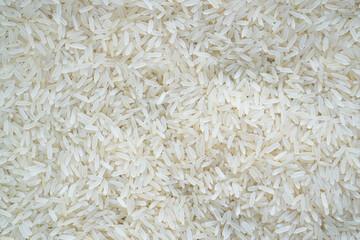 Asian white rice or uncooked white rice. Jasmine rice. Full frame of raw white rice background