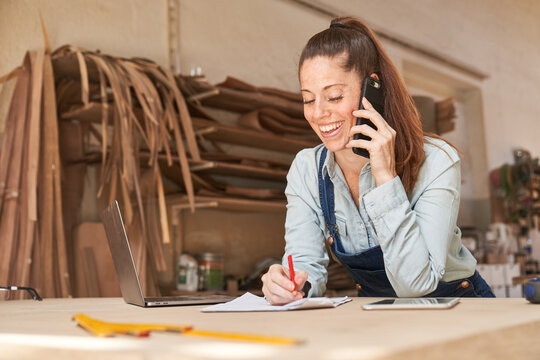 Handyman woman using cell phone in customer service