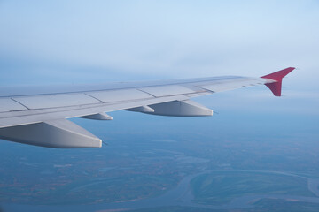 Fototapeta premium airplane window picture with sun on the horizon.