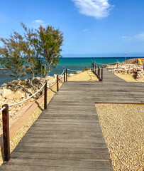 Way to the beach through a wooden path on a sunny day in Alicante, Spain.