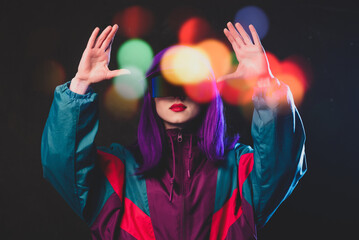 Stylish girl in cyber punk glasses and 80s tracksuit on dark background