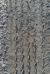 Textured traces, tread on dirty from the ground, sand, wet asphalt from a truck. Photography, concept.