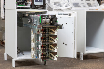 Repair and maintenance of an ATM. Installing cassettes with cash in an ATM. Open ATM safe with banknote storage extended.