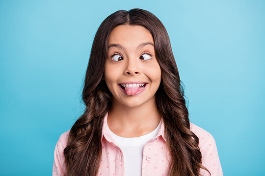 Portrait Of Carefree Curly Hairstyle School Person Show Tongue Squint Eyes Isolated On Blue Color Background