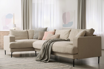 Stylish sofa in modern living room interior