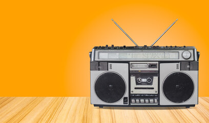 Fototapeta premium retro radio cassette recorder,old radio with old-fashioned tape player isolated on wooden floor texture and mint green gradient wall background.