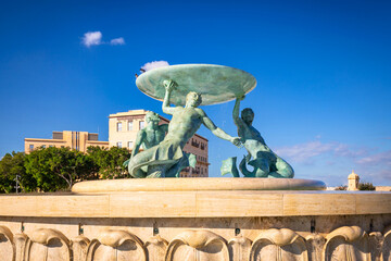 Iconic Triton fountain in front of the City Gate to Valletta, capital of Malta