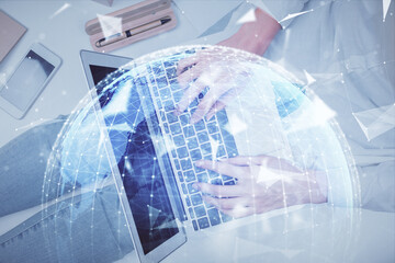 Double exposure of woman hands working on computer and financial theme hologram drawing. Top View. Business concept.