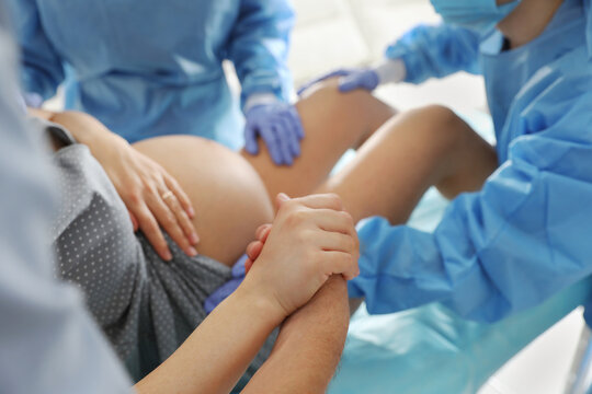 Woman giving child birth in maternity hospital, closeup