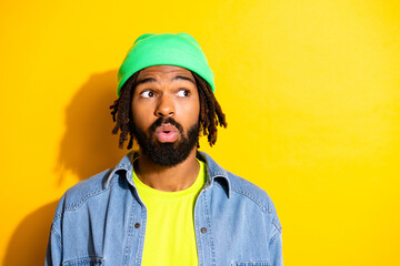 Photo of amazed young afro american man look empty space shocked isolated on yellow color background