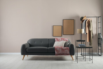 Living room interior with stylish comfortable sofa. Space for text