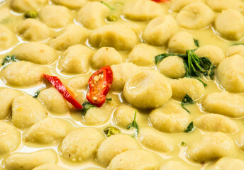 Cooking fish ball green curry in pan, Thai famous food.