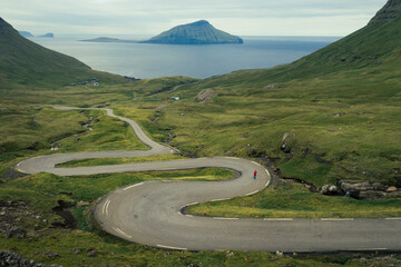 Tiny person on the winding road to Norðradalur on Streymoy, Faroe Islands.