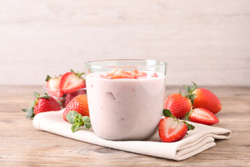 Delicious drink with strawberries on wooden table