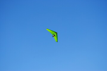 Deltaplane, aile delta vert, dans un ciel sans nuage