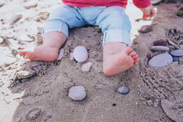 Little baby discovering the sand and sea