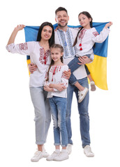 Obraz premium Happy family in national clothes with flag of Ukraine on white background