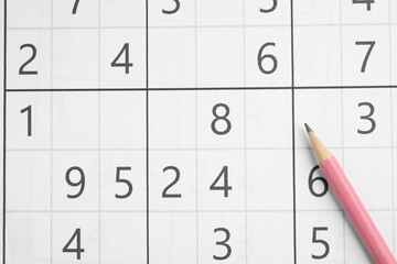 Sudoku and pencil as background, top view