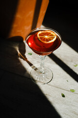 Cocktail in a glass on a stem, red. Alokolny