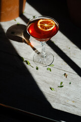 Cocktail in a glass on a stem, red. Alokolny