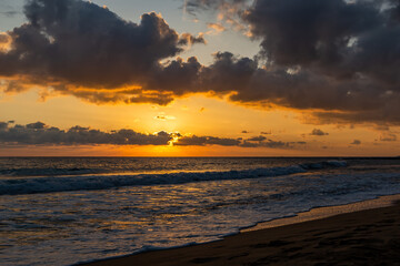 Dramatic sunset over ocean. Sky with clouds.