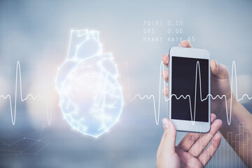 Double exposure of heart sketch hologram and woman holding and using a mobile device. Medical...