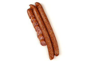 Three sausages lie on a white background.The sausage is sliced. Isolated