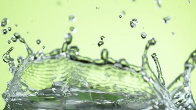 Super slow motion of falling lime slice into splashing water. Filmed on high speed cinema camera, 1000 fps.