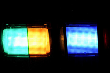 Flash light of a camera with colorful color foils photographed in the studio