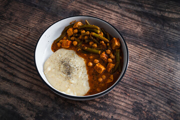 vegan chickpea green beans stew with tofu cubes and mashed potato, healthy plant-based food