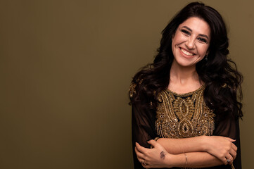 Portrait of beautiful smiling young muslim arabian woman looking at camera, copy space