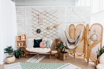 Scandinavian interior with rattan sofa and screen. Vacation mood.