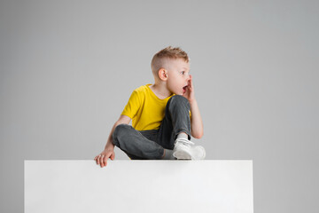 Happy boy isolated on white studio background. Looks happy, cheerful, sincere. Copyspace. Childhood, education, emotions concept