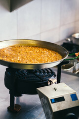 Cooking paella on a special gas stove - Spanish food