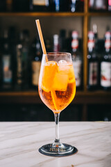 Syringe Aperol with orange and mint in a beautiful glass glass on the bar