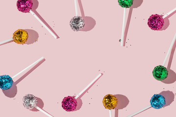 Creative colorful pattern or frame with lollipops and bright pink,yellow,green,blue and silver...