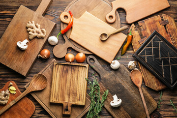 Cutting boards with products on wooden background