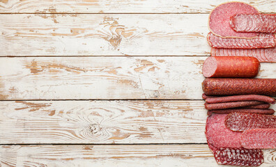 Tasty sausages on wooden background